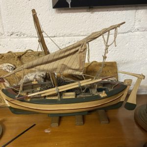 Green and red boat with paddles